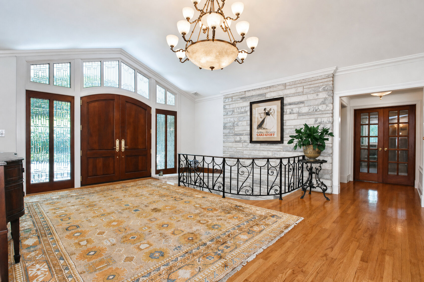 Foyer with chandelier and hardwood floors
