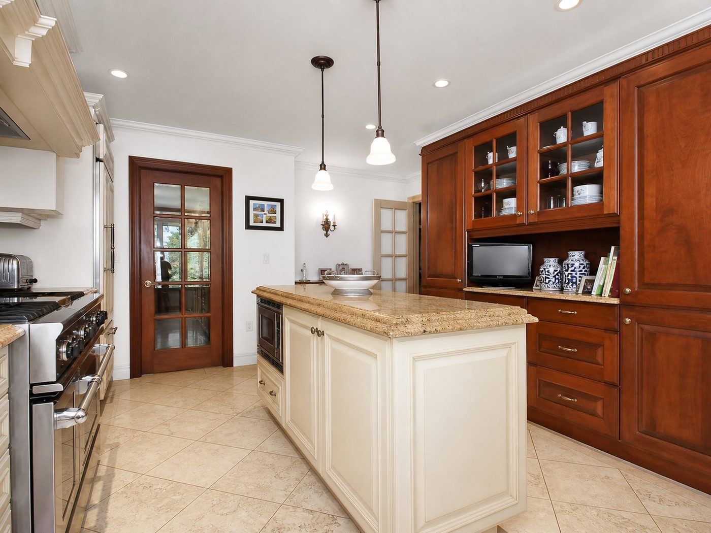 Kitchen with custom cabinetry and granite island