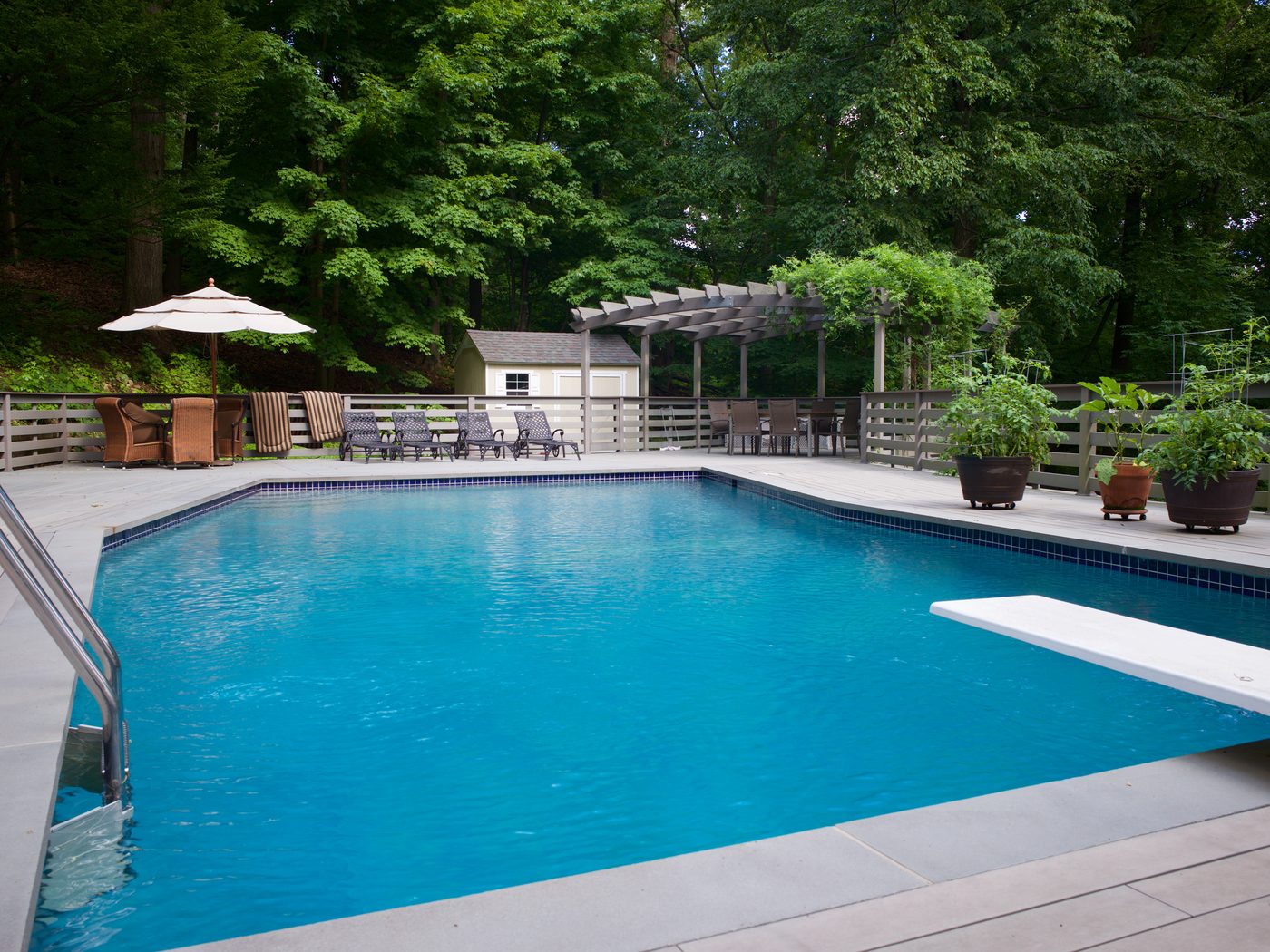 Outdoor pool with deck and pergola
