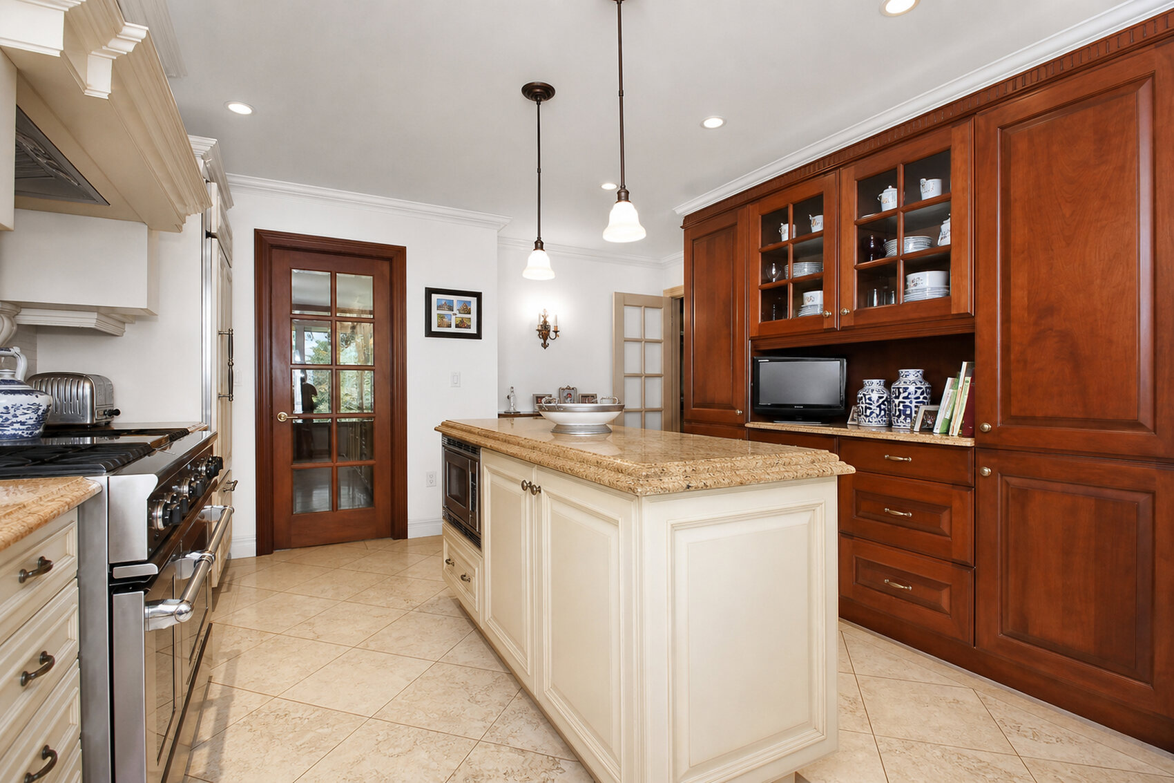 Main kitchen with granite island and custom cabinetry